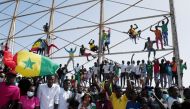 Senegalese fans celebrate as they wait to welcome the Senegal National Soccer Team after their Africa Cup win, in Dakar, Senegal February 7, 2022. REUTERS/ Zohra Bensemra
