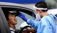 A woman takes a test for the coronavirus disease (COVID-19) at a testing centre in Sydney, Australia, January 5, 2022. REUTERS/Jaimi Joy/File Photo