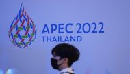  A woman passes by the logo of the APEC Summit 2022 at a department store in Bangkok, Thailand, November 18, 2021. Reuters/Athit Perawongmetha/File Photo