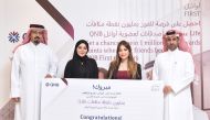 Winner of the 1 Million Life Rewards points members referral campaign with representatives of Ministry of Commerce and Industry and QNB.