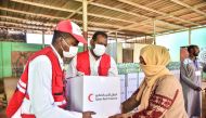 A beneficiary receiving food parcel provided by QRCS to flood affected people in Sudan.