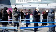 People wait in line to undergo the coronavirus disease (COVID-19) test at a temporary testing site set up in Seoul, South Korea, February 16, 2022. REUTERS/ Heo Ran