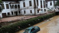 A car is pictured at a river after pouring rains in Petropolis, Brazil, February 16, 2022. REUTERS/Ricardo Moraes