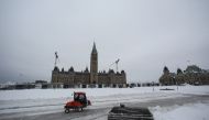 A winter service vehicle drives, as Canadian police officers work to evict the last of the trucks and supporters occupying the downtown core, three weeks after a protest against coronavirus disease (COVID-19) vaccine mandates began, at Parliament Hill in Ottawa, Ontario, Canada, February 20, 2022. REUTERS/Lars Hagberg
