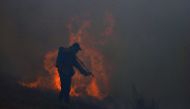 A man works to extinguish the fire that continues to consume trees and pastures in Ituzaingo, province of Corrientes, Argentina February 20, 2022. REUTERS/Matias Baglietto