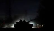 A tank drives along a street in eastern Ukraine following the recognition of their independence, in the separatist-controlled city of Donetsk, Ukraine February 22, 2022. Reuters/Alexander Ermochenko