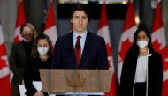 Canada's Prime Minister Justin Trudeau, with Minister of Foreign Affairs Melanie Joly, Deputy Prime Minister and Minister of Finance Chrystia Freeland, and Minister of National Defence Anita Anand, attends a news conference in Ottawa, Ontario, Canada February 24, 2022. REUTERS/Blair Gable
