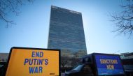 Trucks display electronic messages while protestors demonstrate outside United Nations headquarters, as inside diplomats hold an emergency session of the 193-member U.N. General Assembly on Russia's invasion of Ukraine, in Manhattan in New York City, New York, U.S., February 28, 2022. REUTERS/Mike Segar
