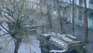 A military truck and tank are seen on a street of Kherson, Ukraine March 1, 2022, in this screen grab from a video obtained by Reuters. 
 