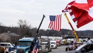 Hundreds of vehicles including 18-wheeler trucks, RVs and other cars depart the Hagerstown Speedway after some of them arrived as part of a convoy that traveled across the country headed to Washington D.C. to protest COVID-19 related mandates and other issues in Hagerstown, Maryland, U.S., March 6, 2022. REUTERS/Stephanie Keith

