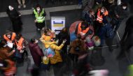 Volunteers in high-visibility clothing help refugees fleeing Russia's invasion of Ukraine who have arrived on a train from Poland at the central station in Berlin, Germany, March 6, 2022. Picture taken with a slow shutter speed. REUTERS/Annegret Hilse
