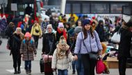 People arrive to a temporary accommodation and transport hub for refugees, after fleeing the Russian invasion of Ukraine, in Przemysl, Poland, March 8, 2022. REUTERS/Fabrizio Bensch

