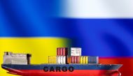 FILE PHOTO: A cargo ship boat model is pictured in front of Ukraine's and Russian's flags in this illustration taken March 3, 2022. REUTERS/Dado Ruvic/Illustration/File Photo
