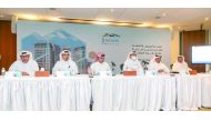 H E Salah bin Ghanem Al Ali (third right), Chairman of the Board of Directors and other officials during the Ordinary General Assembly Meeting of Barwa Real Estate Company held yesterday.