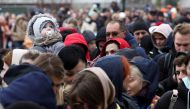 People wait outside an immigration office after fleeing from Ukraine to Belgium, following Russia's invasion of Ukraine, in Brussels, Belgium March 15, 2022. REUTERS/Yves Herman
