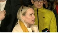 Marina Ovsyannikova, a Channel One employee who staged an on-air protest as she held up a anti-war sign behind a studio presenter, speaks to the media as the leaves the court building in Moscow, Russia March 15, 2022 in this still image taken from a video. REUTERS TV via REUTERS
