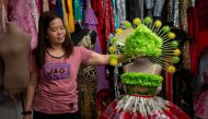 Nora Buenviaje shows an outfit made of recycled sacks of rice, plastic bags and straws, at her shop in Cainta, Rizal Province, Philippines, March 3, 2022. Picture taken March 3, 2022. REUTERS/Lisa Marie David
 