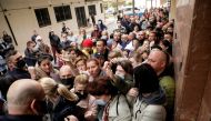 Ukrainian refugees queue to get one of the 100 daily appointments at the documentation office to apply for temporary protection approved by the European Union that allows residence and a work permit, in Torrevieja, Spain March 15, 2022. REUTERS/Eva Manez