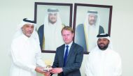 Ambassador of France H E Jean-Baptiste Faivre being honoured by Assistant Undersecretary for Public Services Affairs at the Ministry of Municipality, Sherida Sultan Al Rumaihi, during the workshop yesterday. 