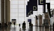 A traveller walks in the departure hall at the Hong Kong International Airport amid the coronavirus disease (COVID-19) pandemic in Hong Kong, China, March 21, 2022. REUTERS/Tyrone Siu