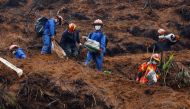 Rescue workers work at the site where a China Eastern Airlines Boeing 737-800 plane flying from Kunming to Guangzhou crashed, in Wuzhou, Guangxi Zhuang Autonomous Region, China March 24, 2022. REUTERS/Carlos Garcia Rawlins