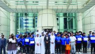 Dr. R Seetharaman, Group CEO of Doha Bank pose for a group photo with offcials and students.