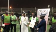 Ambassador of Nigeria to Qatar H E Yakubu Abdullahi Ahmed and NIDO-Qatar President Ajibade Lateef receiving the certificate of affiliation from IWFF Asia and Qatar President, Farhan Al Sheikh Al Sayed.