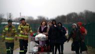 Ukrainian refugees cross the Ukraine-Poland border, amid the Russian invasion of Ukraine, in Medyka, Poland, March 26, 2022. REUTERS/Hannah McKay/File Photo