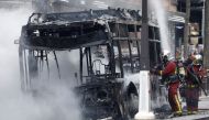 Firefighters work at the scene where a bus caught fire in Paris, France, April 4, 2022. REUTERS/Benoit Tessier