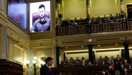 Spanish Prime Minister Pedro Sanchez speaks as Ukrainian President Volodymyr Zelenskiy appears on a screen as he addresses members of Spanish parliament via video link, amid Russia's invasion of Ukraine, in Madrid, Spain, April 5, 2022. REUTERS.