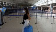 A traveller wearing a protective face mask is seen at Larnaca International Airport, after Cyprus opened up its airports following a nationwide lockdown amid the spread of the coronavirus disease (COVID-19), in Larnaca, Cyprus June 9, 2020. REUTERS/Yiannis Kourtoglou/File Photo