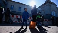 FILE PHOTO: People with children wait at the train station during an evacuation of women, children and people with disabilities, amid Russia's invasion of Ukraine, in Dnipro, Ukraine March 12, 2022. REUTERS/Mykola Synelnikov/File Photo
