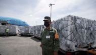 A member of the National Guard looks on as a batch of AstraZeneca coronavirus disease (COVID-19) vaccines, delivered under the COVAX scheme, is unloaded from a KLM Boeing 787 at Benito Juarez International Airport in Mexico City, Mexico May 27, 2021. REUTERS/Henny Romero/File Photo
