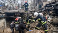 Rescuers carry a body of a person found under debris of a residential building destroyed during Russia's invasion in the town of Borodianka, Kyiv region, Ukraine April 9, 2022. Reuters/Vladyslav Musiienko