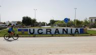 A cyclist rides past a sign in a roundabout that reads 'Ukraine' after it was changed from the original name of the town, as other street names were also changed to include names of Ukrainian cities in support of Ukraine, amid Russia's invasion, in the town of Fuentes de Andalucia, near Seville, southern Spain, April 16, 2022. REUTERS/Jon Nazca
