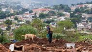 A search and rescue team member uses a dog to search for bodies in Dassenhoek near Durban, South Africa, April 17, 2022. REUTERS/Rogan Ward