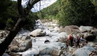 A search and rescue team uses a dog to search for bodies in Umbumbulu near Durban, South Africa, April 18, 2022. REUTERS/Rogan Ward
