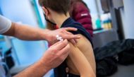 A boy gets children's dose of Comirnaty, the Pfizer-BioNTech vaccine against the coronavirus disease (COVID-19), at a vaccination centre in Ebersberg near Munich, Germany, December 15, 2021.REUTERS/Lukas Barth

