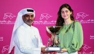 Manager of Al Uqda Complex Department Abdulaziz Jassim Al Boenain presents the winner's trophy to the representative of Umm Qarn after King Shalaa landed the End Of Season Cup at Al Rayyan Racecourse, yesterday.