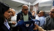 Walid Al-Omari, Al Jazeera's Palestine bureau Chief, holds the flak jacket that Al Jazeera reporter Shireen Abu Akleh was wearing when she was killed. (REUTERS/Mohamad Torokman)