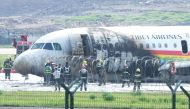 Rescue workers are seen at the site where an Airbus A319 plane of Tibet Airlines caught fire after an aborted takeoff, at Chongqing Jiangbei International Airport in Chongqing, China May 12, 2022. cnsphoto via REUTERS
