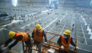 Workers labour to convert the National Exhibition and Convention Center into a makeshift hospital for the coronavirus disease (COVID-19), in Shanghai, China April 7, 2022. cnsphoto via REUTERS/File Photo