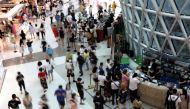 People wearing face masks shop at the Sanya International Duty-Free Shopping Complex in Sanya, Hainan province, China November 25, 2020. REUTERS/Tingshu Wang/File Photo
