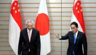 Japan’s Prime Minister Fumio Kishida invites Singapore's Prime Minister Lee Hsien Loong to take a seat at the start of their meeting at Kishida's official residence in Tokyo, Japan May 26, 2022. Franck Robichon/Pool via Reuters