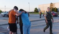 People pray at the CrossRoad Baptist Church parking lot after a shooting at Cornerstone Church in Ames, Iowa, U.S. June 2, 2022. Picture taken June 2, 2022. Nirmalendu Majumdar/USA Today Network via REUTERS. NO RESALES. NO ARCHIVES. MANDATORY CREDIT

