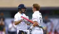 England's Ollie Pope celebrates reaching his century with Joe Root Action Images via Reuters/Andrew Boyers
