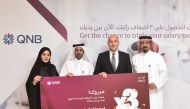 QNB officials pose for a group photo with the winner the ‘Triple your Salary’ campaign.