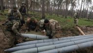 Military sappers place a combat part of a Russian Uragan multiple rocket launch shell left after Russia's invasion in Kyiv Region, Ukraine, recently. (Reuters/Mykola Tymchenko)