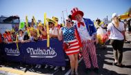 People attend the 2022 Nathan’s Famous Fourth of July International Hot Dog Eating Contest as it returns to the iconic Nathan’s Famous flagship restaurant after the easing of COVID-19 restrictions, at Coney Island in New York, US, July 4, 2022. (Reuters/Eduardo Munoz)