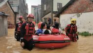 Rescue workers evacuate flood-affected residents with a dinghy after heavy rainfall brought by Typhoon Chaba flooded the villages, in Beihai, Guangxi Zhuang Autonomous Region, China July 4, 2022. cnsphoto via REUTERS